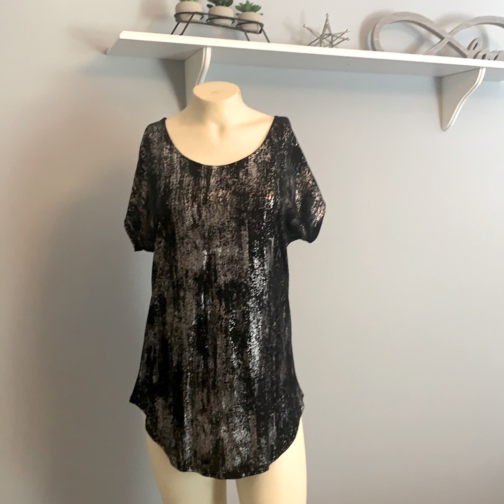 Dressy top with silver, shimmering accents.